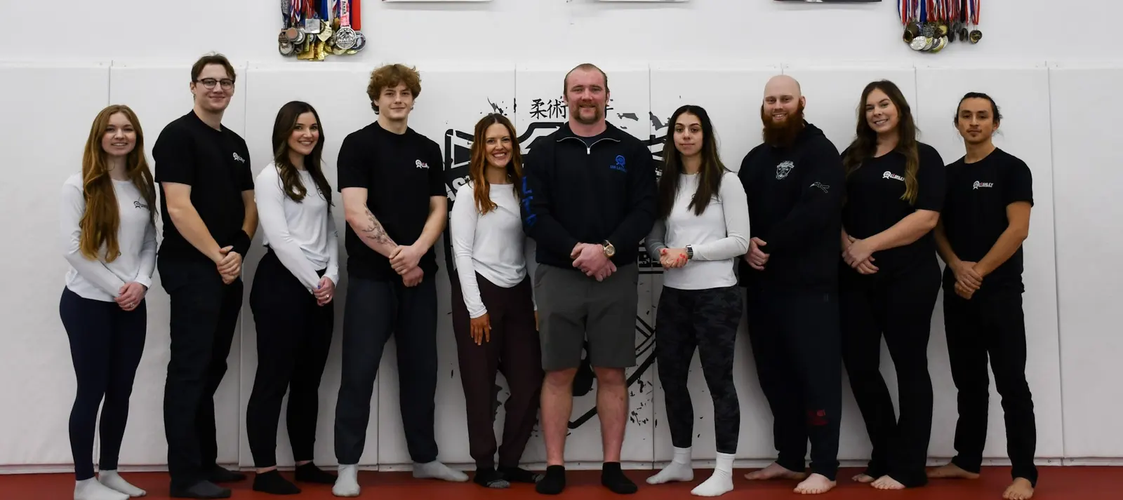 The Lashley Training Center coaching team on the mats